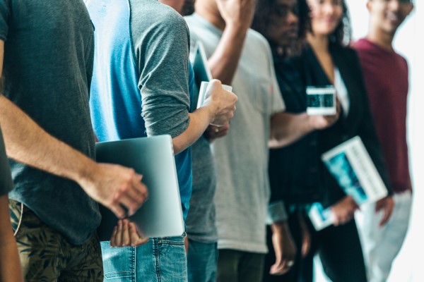 A row of college students stand in a line